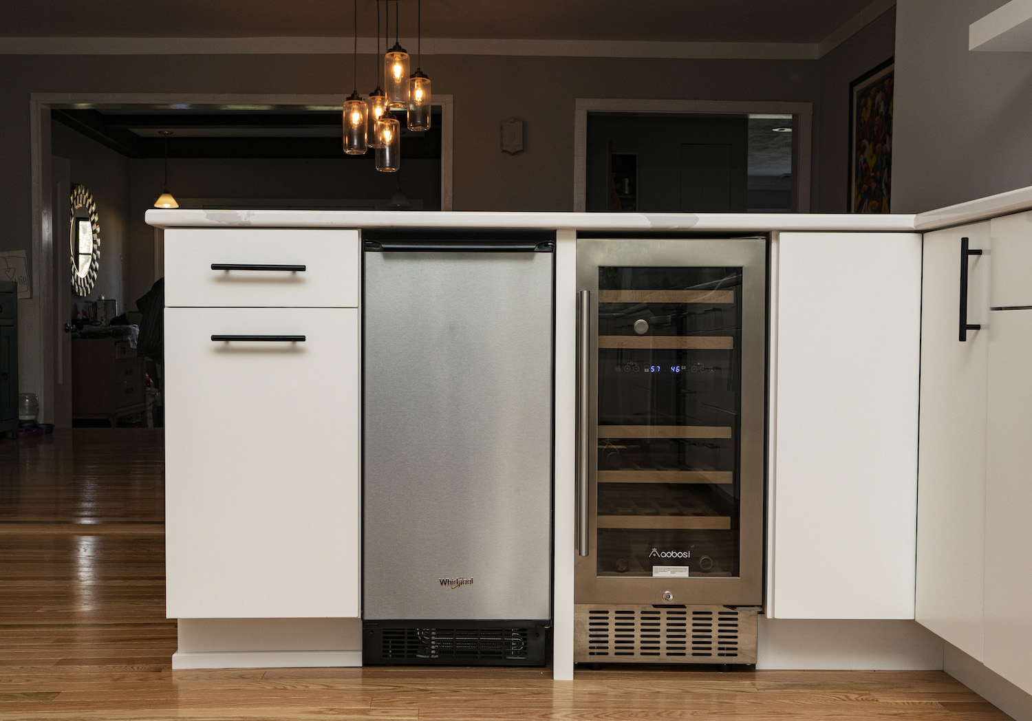 trash press and wine cooler built into kitchen